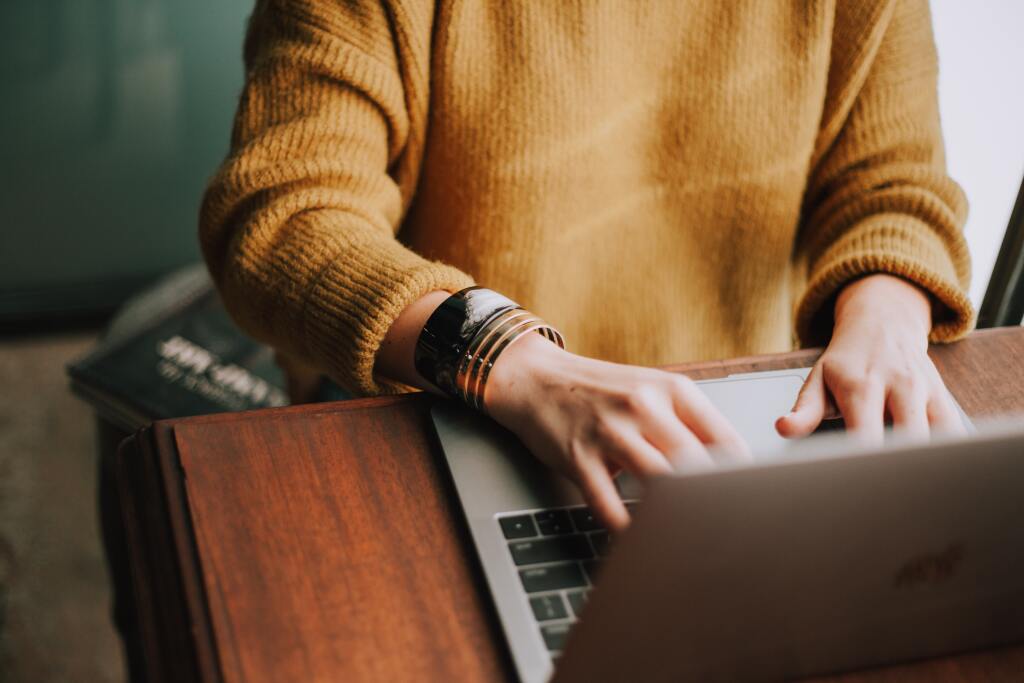 A person on their laptop searching the Internet.